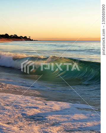 Ocean wave breaking on shore during sunset at a quiet beach location 130080900