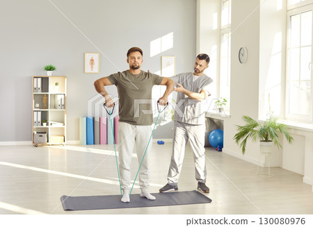 Physical therapy exercise, male patient rehabilitation, physical therapist nurse, traumatologist  130080976