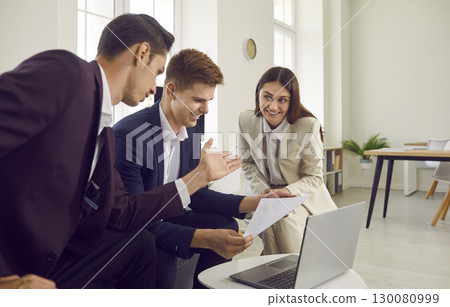 Three young business people at work in office talking and having discussion. Three young business people at work in office talking and having discussion. 130080999