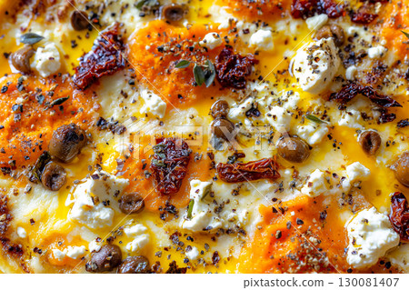 Close-up view of a delicious pizza topped with roasted pumpkin, feta, and sun-dried tomatoes 130081407