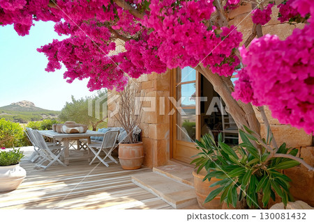 Gorgeous garden atrium in Ibiza style with olive tree and vibrant flowers 130081432