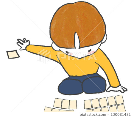 一個男孩撿起一張歌留多卡 一個男孩撿起一張歌留多卡 130081481