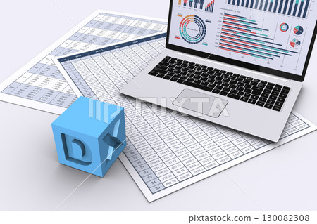 A laptop computer displaying visualized data and a cube engraved with the letters DX A laptop computer displaying visualized data and a cube engraved with the letters DX 130082308