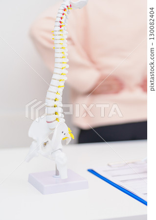 Elderly Patient consulting Doctor with Spine anatomy for Spinal Cord Disorder and disease, Back pain, Lumbar, Sacral pelvis, Cervical neck, Thoracic, Coccyx, Orthopedist, chiropractic, Office Syndrome 130082404