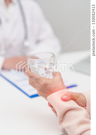 Senior woman with Tremor hand during taking glass of water in hospital. Parkinson disease April awareness month, Carpal Tunnel Syndrome, rheumatoid and brain injury and Neurological disorder concept Senior woman with Tremor hand during taking glass of water in hospital. Parkinson disease April awareness month, Carpal Tunnel Syndrome, rheumatoid and brain injury and Neurological disorder concept 130082413