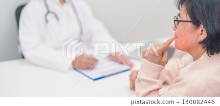 Elderly woman Patient having Toothache and consulting Doctor to teeth disease. Senior Health Medical Diagnosis. Oral Teeth decay, Scrape off tartar. March Oral health, Dentist day and Consultation 130082446