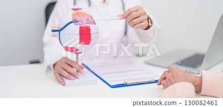 Elderly Patient consulting Doctor to Eye disease, Senior Medical Diagnosis. Anatomy Eye model for Cataract, Glaucoma, Age Related Macular Degeneration, Diabetic Retinopathy, Vitreous, health concept Elderly Patient consulting Doctor to Eye disease, Senior Medical Diagnosis. Anatomy Eye model for Cataract, Glaucoma, Age Related Macular Degeneration, Diabetic Retinopathy, Vitreous, health concept 130082461