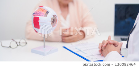 Elderly Patient consulting Doctor to Eye disease, Senior Medical Diagnosis. Anatomy Eye model for Cataract, Glaucoma, Age Related Macular Degeneration, Diabetic Retinopathy, Vitreous, health concept Elderly Patient consulting Doctor to Eye disease, Senior Medical Diagnosis. Anatomy Eye model for Cataract, Glaucoma, Age Related Macular Degeneration, Diabetic Retinopathy, Vitreous, health concept 130082464