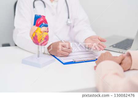 Doctor with Heart anatomy model. Elderly Patient consultation medical health for Cardiovascular Diseases, Atherosclerosis, Hypertensive, Heart attack, heart failure and world Heart day concept 130082476