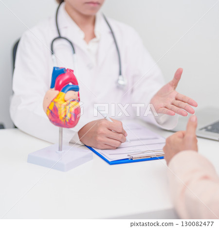 Doctor with Heart anatomy model. Elderly Patient consultation medical health for Cardiovascular Diseases, Atherosclerosis, Hypertensive, Heart attack, heart failure and world Heart day concept 130082477