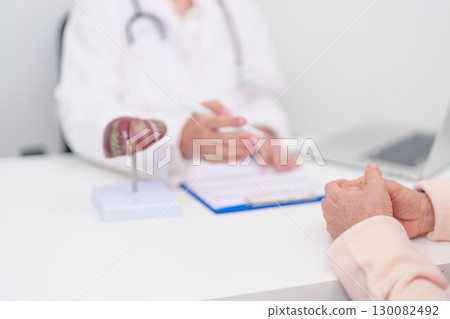 Doctor with human Liver anatomy. Elderly Patient consultation medical health for Liver cancer and Tumor, Jaundice, Viral Hepatitis, Cirrhosis, Failure, Enlarged, Hepatic Encephalopathy, Ascites Fluid 130082492