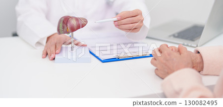 Doctor with human Liver anatomy. Elderly Patient consultation medical health for Liver cancer and Tumor, Jaundice, Viral Hepatitis, Cirrhosis, Failure, Enlarged, Hepatic Encephalopathy, Ascites Fluid Doctor with human Liver anatomy. Elderly Patient consultation medical health for Liver cancer and Tumor, Jaundice, Viral Hepatitis, Cirrhosis, Failure, Enlarged, Hepatic Encephalopathy, Ascites Fluid 130082495