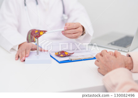 Doctor with human Liver anatomy. Elderly Patient consultation medical health for Liver cancer and Tumor, Jaundice, Viral Hepatitis, Cirrhosis, Failure, Enlarged, Hepatic Encephalopathy, Ascites Fluid Doctor with human Liver anatomy. Elderly Patient consultation medical health for Liver cancer and Tumor, Jaundice, Viral Hepatitis, Cirrhosis, Failure, Enlarged, Hepatic Encephalopathy, Ascites Fluid 130082496