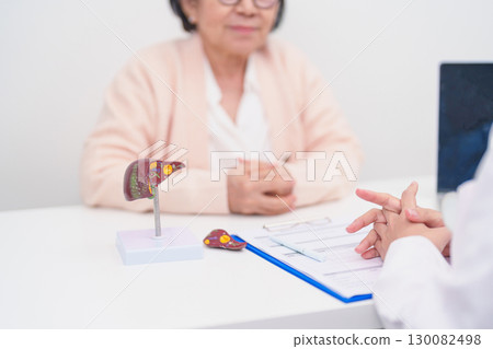 Doctor with human Liver anatomy. Elderly Patient consultation medical health for Liver cancer and Tumor, Jaundice, Viral Hepatitis, Cirrhosis, Failure, Enlarged, Hepatic Encephalopathy, Ascites Fluid 130082498