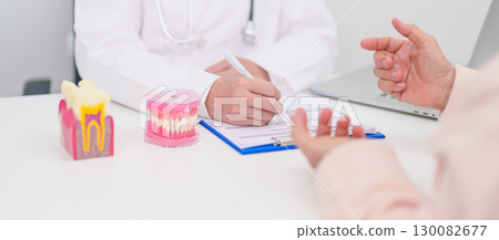 Elderly Patient consulting Dentist to Tooth disease, Senior Health Medical Diagnosis. Anatomy teeth model for Oral Teeth decay, Scrape off tartar. March Oral health, Dentist Day, False Teeth concept 130082677