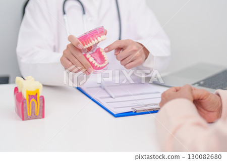 Elderly Patient consulting Dentist to Tooth disease, Senior Health Medical Diagnosis. Anatomy teeth model for Oral Teeth decay, Scrape off tartar. March Oral health, Dentist Day, False Teeth concept Elderly Patient consulting Dentist to Tooth disease, Senior Health Medical Diagnosis. Anatomy teeth model for Oral Teeth decay, Scrape off tartar. March Oral health, Dentist Day, False Teeth concept 130082680