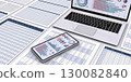 A PC displaying business data and a printed document 130082840