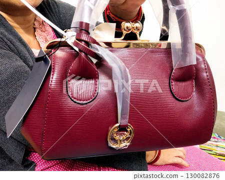 Elegant Burgundy Handbag with Gold Clasp 130082876