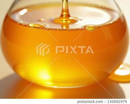 Golden Delicious Honey Liquid Flowing Inside A Glass Container Food Ingredient Golden Delicious Honey Liquid Flowing Inside A Glass Container Food Ingredient 130082979