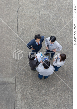 Group photo of company employees standing outside 130083325