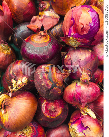 Fresh purple onions stacked together at market Fresh purple onions stacked together at market 130083716
