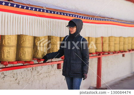 One Tibetan lady Spin the Tibetan Prayer Wheels in Potala place,Lhasa,China 130084474