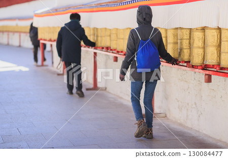One Tibetan lady Spin the Tibetan Prayer Wheels in Potala place,Lhasa,China One Tibetan lady Spin the Tibetan Prayer Wheels in Potala place,Lhasa,China 130084477