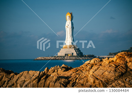 Buddhaism Guanyin statue at seaside in nanshan temple, hainan island , China, Words mean mercy and blessing. 130084484