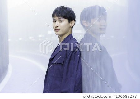 Portrait of a young man in a navy blue jacket 130085258