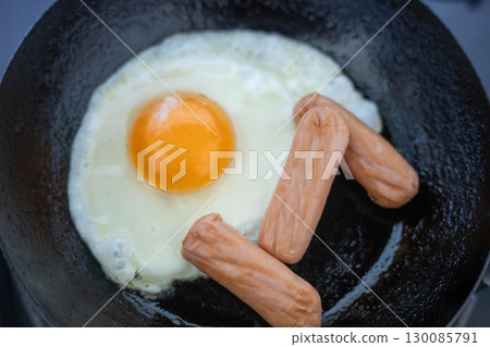 Bake a fried egg in a frying pan Bake a fried egg in a frying pan 130085791