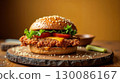 Freshly made homemade chicken burger with sesame seeds on a wooden serving platter. 130086167