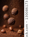 Dynamic shot of falling chocolate truffles and whole coffee beans with a sprinkle of cocoa. 130086173