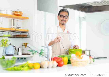 Kitchen Middle-aged man cooking Kitchen Middle-aged man cooking 130086390