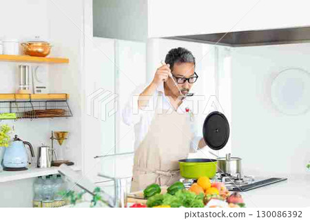 Kitchen Middle-aged man cooking 130086392