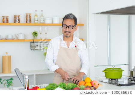 Kitchen Middle-aged man cooking Kitchen Middle-aged man cooking 130086658