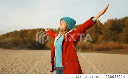 Happy relaxed smiling young woman on beach, enjoying amazing landscape, peace on sea coast Happy relaxed smiling young woman on beach, enjoying amazing landscape, peace on sea coast 130088314