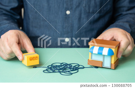 A man demonstrates the complex logistics of delivering goods to store shelves, supply chain difficulties and distribution management 130088705
