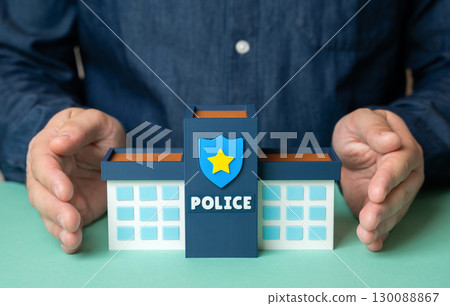 A man takes care of a police station with his own hands. Investments and funding in security and law enforcement services, protecting public order and community safety 130088867