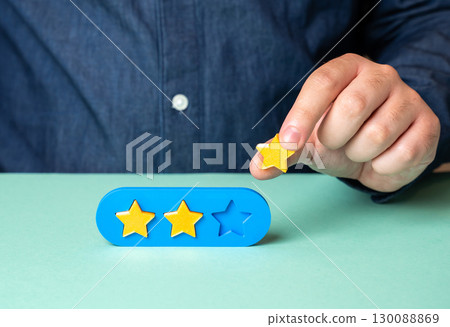 The man holds the third star rating. Award the maximum score. Reviews and feedbacks, reflecting customer satisfaction and recognition of quality service 130088869