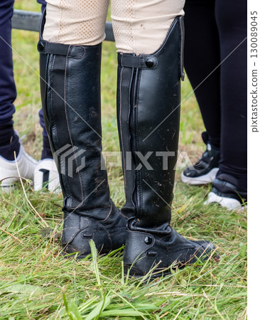 Lady wearing black riding boots Lady wearing black riding boots 130089045