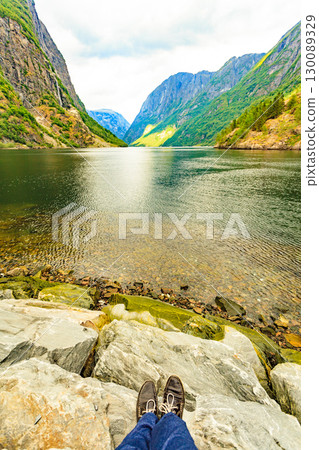 Tourist enjoy fjord view, Norway 130089329