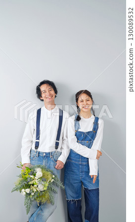 Couple photo of a man and woman wearing denim 130089532
