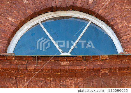 Rustic architectural design featuring a half-circle shaped window 130090055