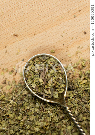 Natural Italian Spice Dried Chopped Oregano in a Spoon, Place for Text 130090391
