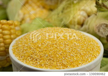 Close-up of raw uncooked gluten-free corn grits. Close-up of raw uncooked gluten-free corn grits. 130090462