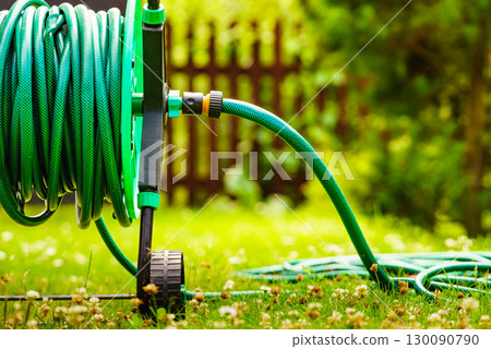 Garden hose for watering plants in garden Garden hose for watering plants in garden 130090790