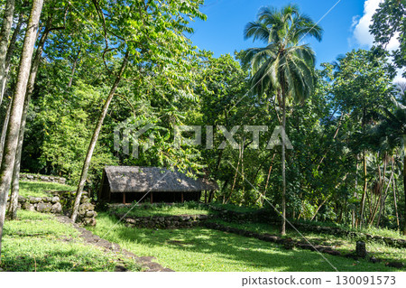 Thatched-roof building at Kamuihei archaeological site, Nuku Hiva, Marquesas Islands. French Polynesia Thatched-roof building at Kamuihei archaeological site, Nuku Hiva, Marquesas Islands. French Polynesia 130091573