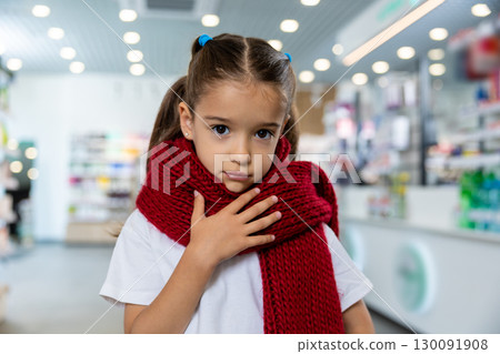 Little cute girl with a red scarf around her neck suffering from a sore throat Little cute girl with a red scarf around her neck suffering from a sore throat 130091908