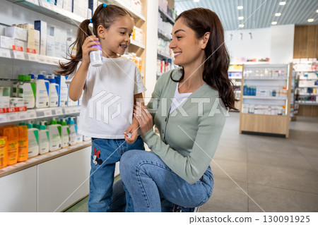 Mom and daughter in the pharmacy choosing medicines Mom and daughter in the pharmacy choosing medicines 130091925
