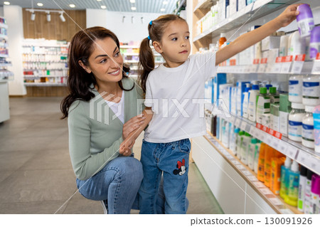 Mom and daughter in the pharmacy choosing medicines Mom and daughter in the pharmacy choosing medicines 130091926